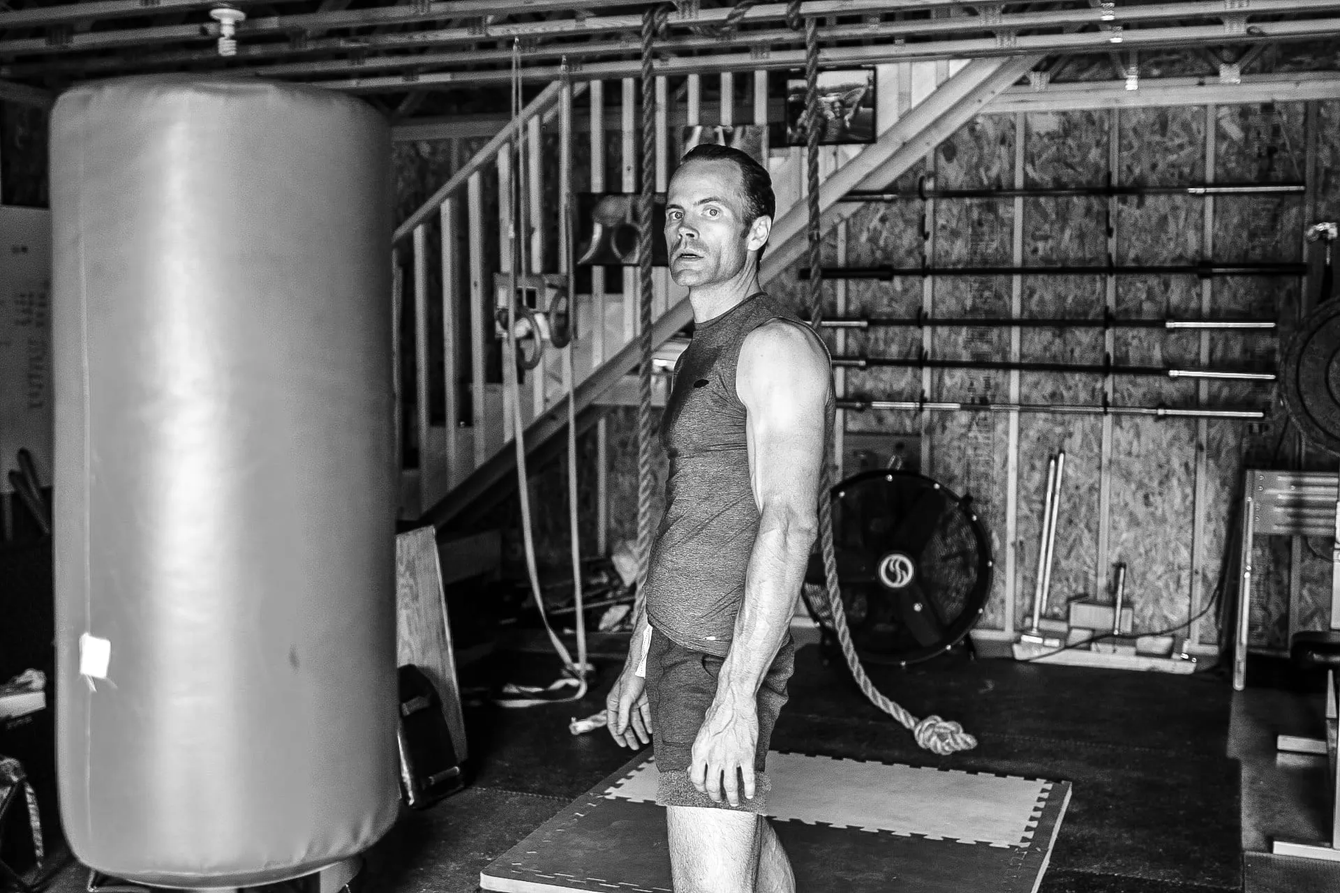 Portrait of Anita in a red top, smiling, against a soft green garden background